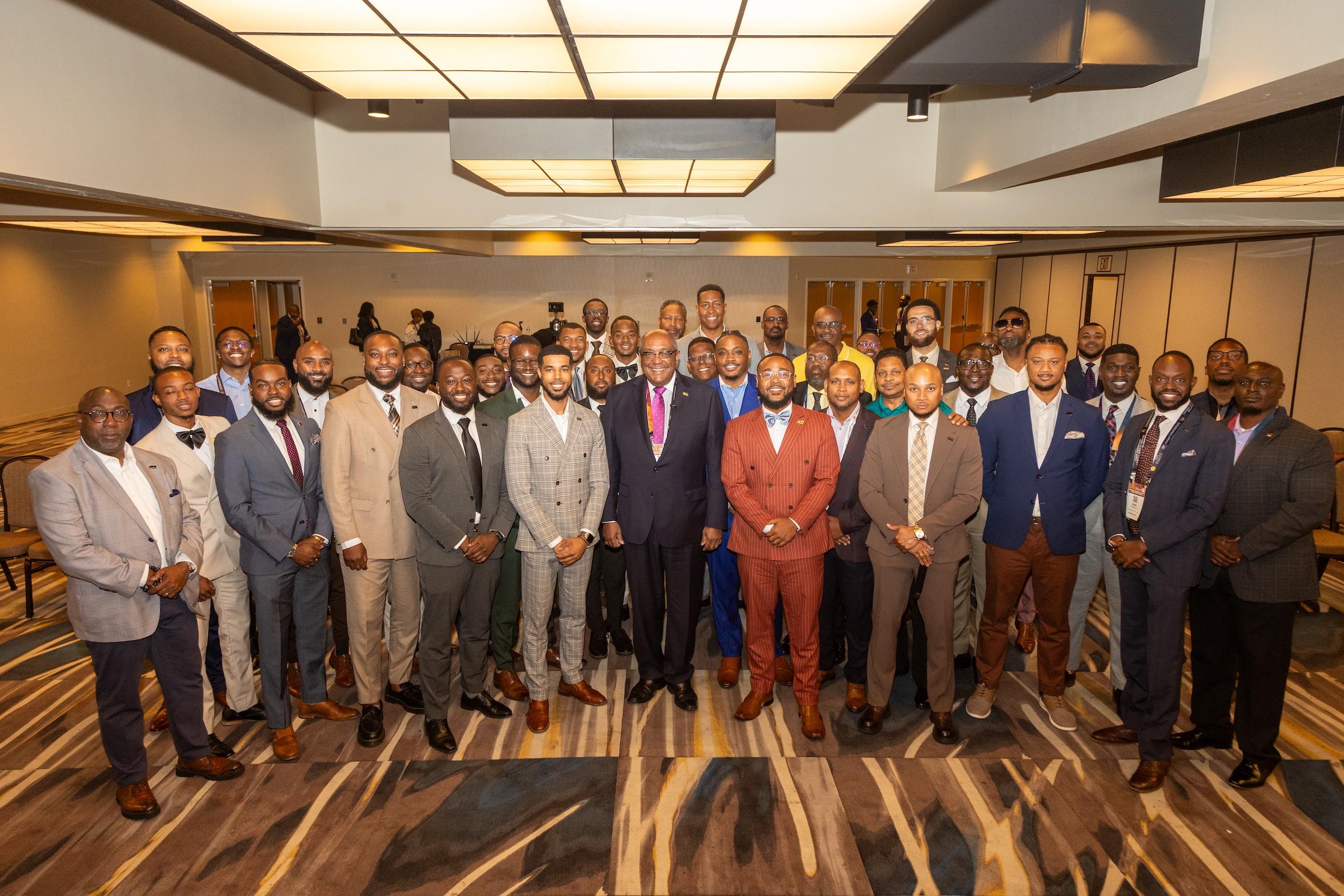 Young professionals pose for group photo at conference session.